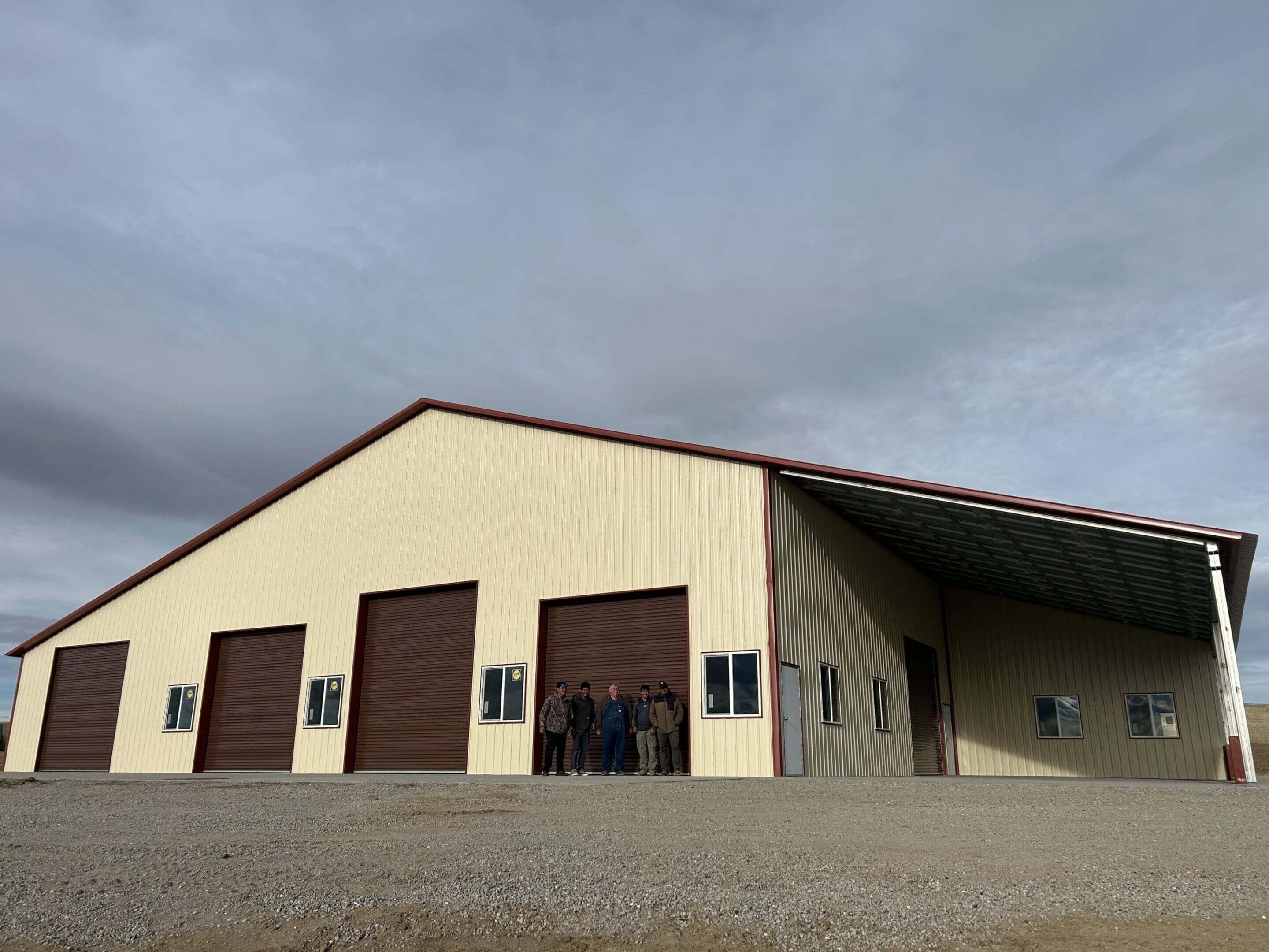 Large beige warehouse with brown doors.