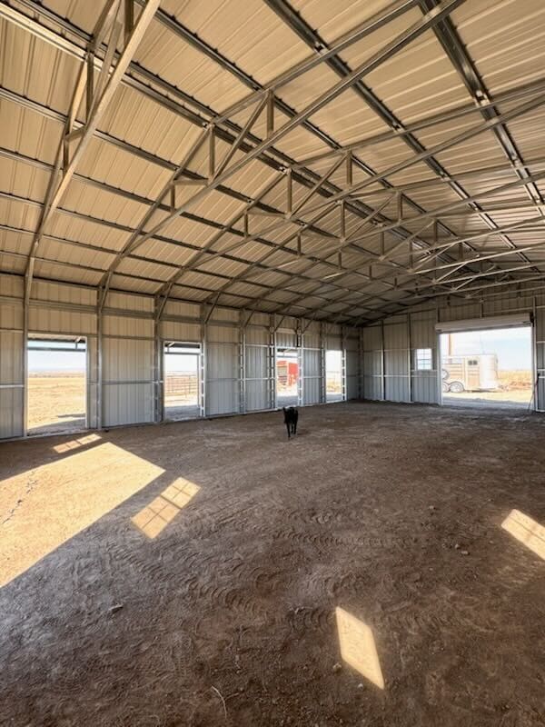 Interior of a large, empty metal warehouse.