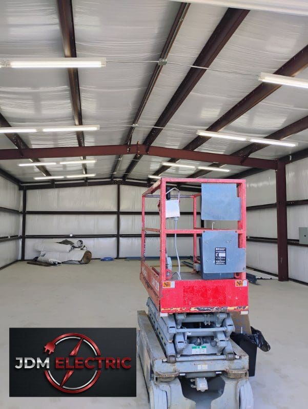 Red lift inside a large, empty warehouse.